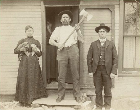 vintage photo of man with ax, women with two cats, and silly looking man.