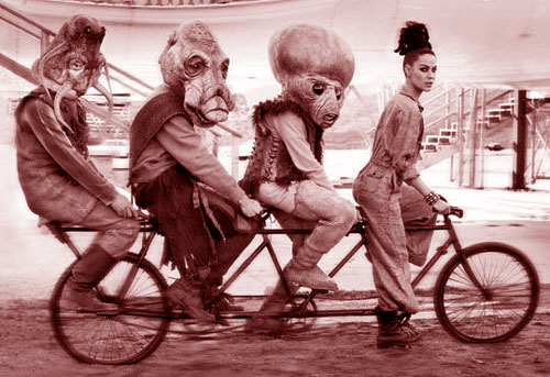 daisy Stagbys riding four-seater bike with three Cthulu