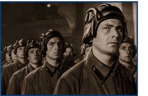 Picture of c troop, in funny hats.  Guy in front looks uncertain.