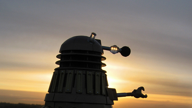 model of a Dalek, as it looks out at a morning sunrise